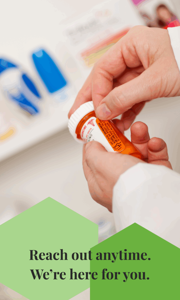 Close-up of hands exchanging a prescription bottle with the message “Reach out anytime. We’re here for you.”
